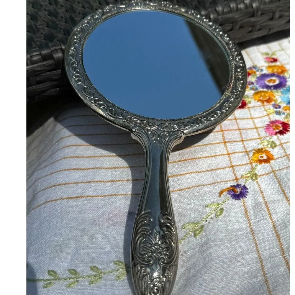 Vintage silver tone hand mirror embossed design on back so pretty